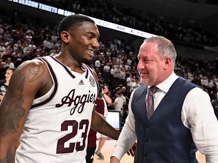 Texas A&M coach Buzz Williams and guard Tyrece Radford embrace after a win against the Alabama.